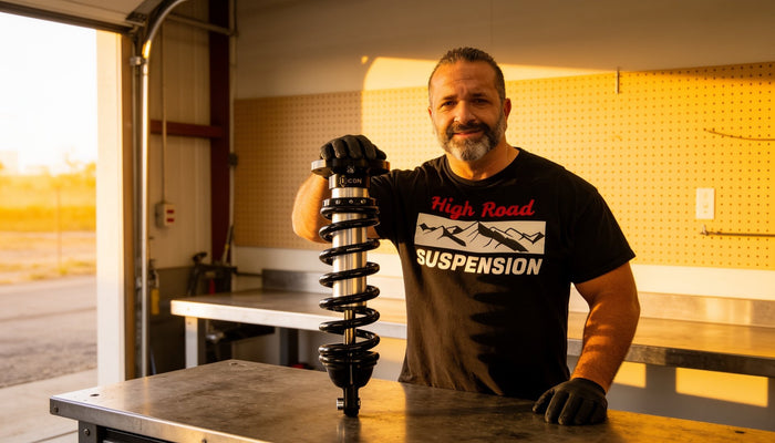 Coilovers with protective covers and limit straps